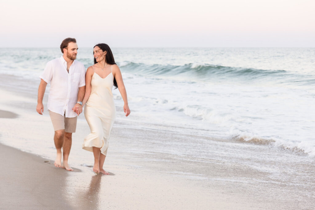 Couple walking together along the shoreline at Fire Island National Seashore during a peaceful summer evening.
