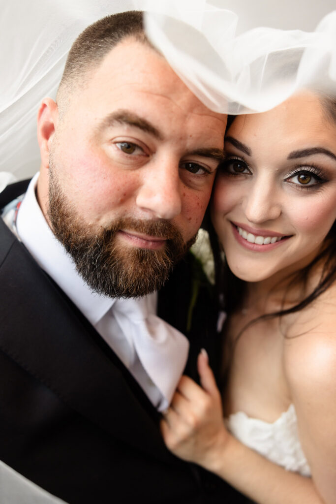 Romantic bride and groom portrait beneath the veil during their Harbor Club at Prime wedding.