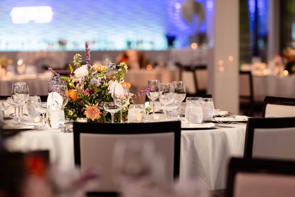 Elegant reception décor with floral centerpieces and candlelight.