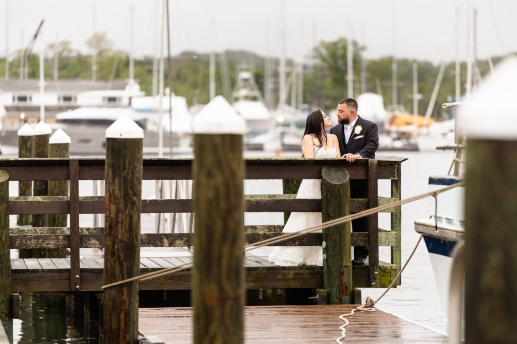 Romantic waterfront portrait on the docks during a Harbor Club at Prime wedding overlooking Huntington Harbor.