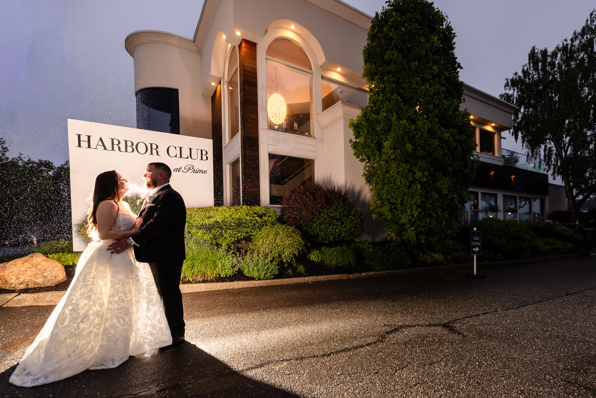 Bride and groom photographed outside Harbor Club at Prime at night during their Harbor Club at Prime wedding.