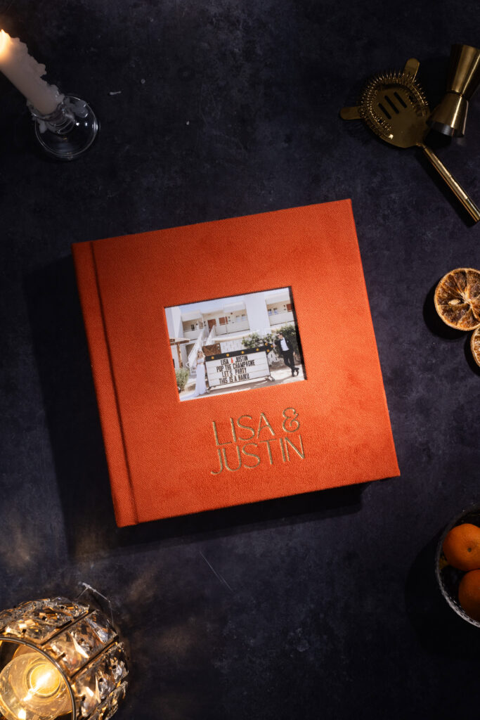 Custom orange linen wedding album with personalized cover window.