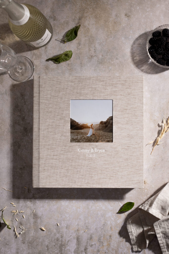 Neutral linen wedding album with a custom cover image and names.