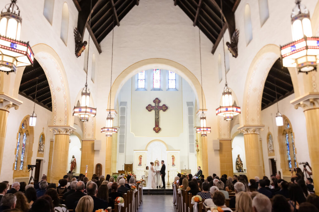 Wide view of Lauren and Joe's wedding ceremony inside St. Brigid's Roman Catholic Church in Westbury, New York.
