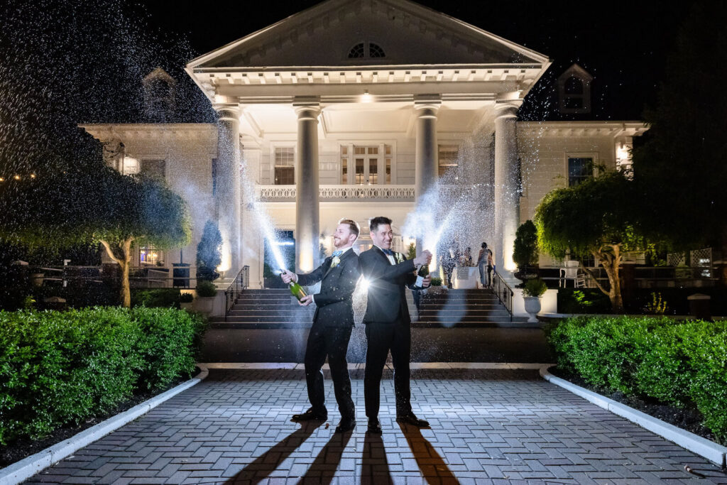 Newlyweds celebrating with champagne outside an elegant wedding venue at night showing Long Island wedding cost