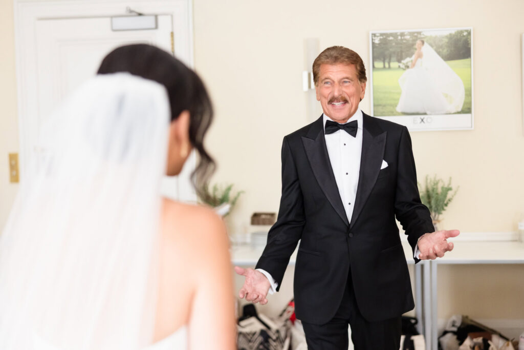 Christine's father smiles as he sees her dressed as a bride before the wedding celebration at The Muttontown Club.