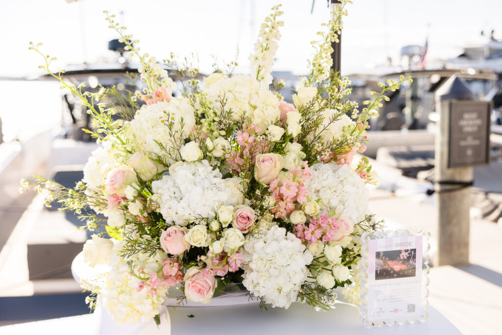 White hydrangeas and blush roses arranged beside the marina during an event at EHP Resort in East Hampton.