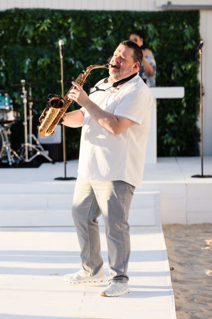 Saxophone player performing live beside the Great Lawn at EHP Resort in East Hampton.