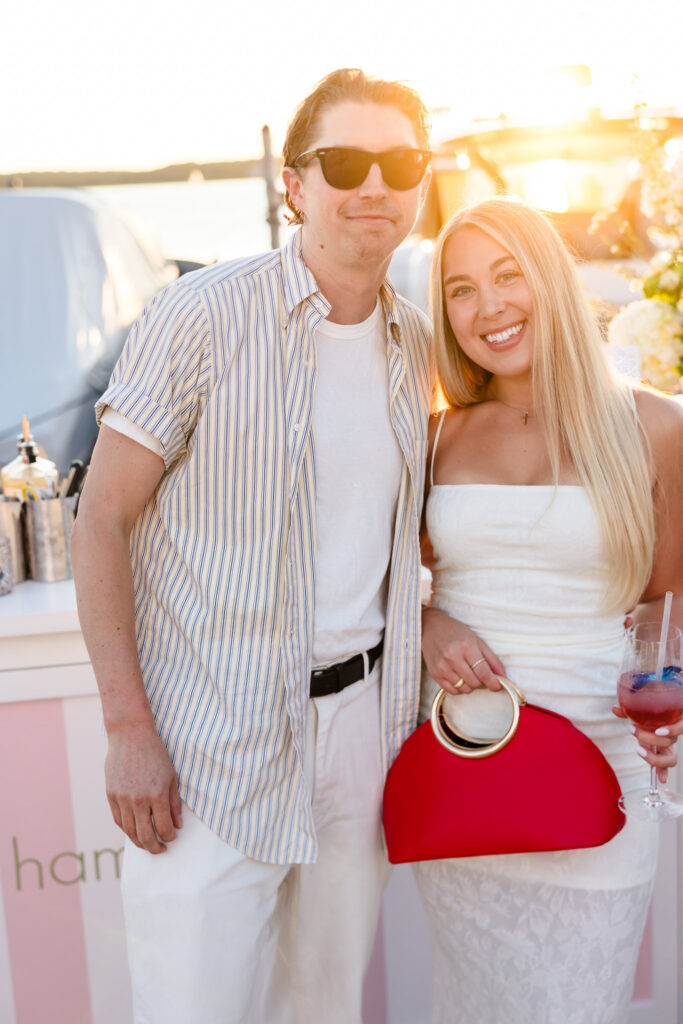 Couple photographed in warm sunset light beside Three Mile Harbor at EHP Resort and Marina.