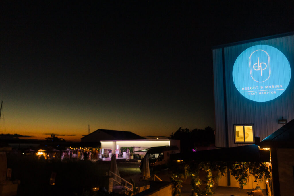 EHP Resort and Marina illuminated against the evening sky on Three Mile Harbor in East Hampton.