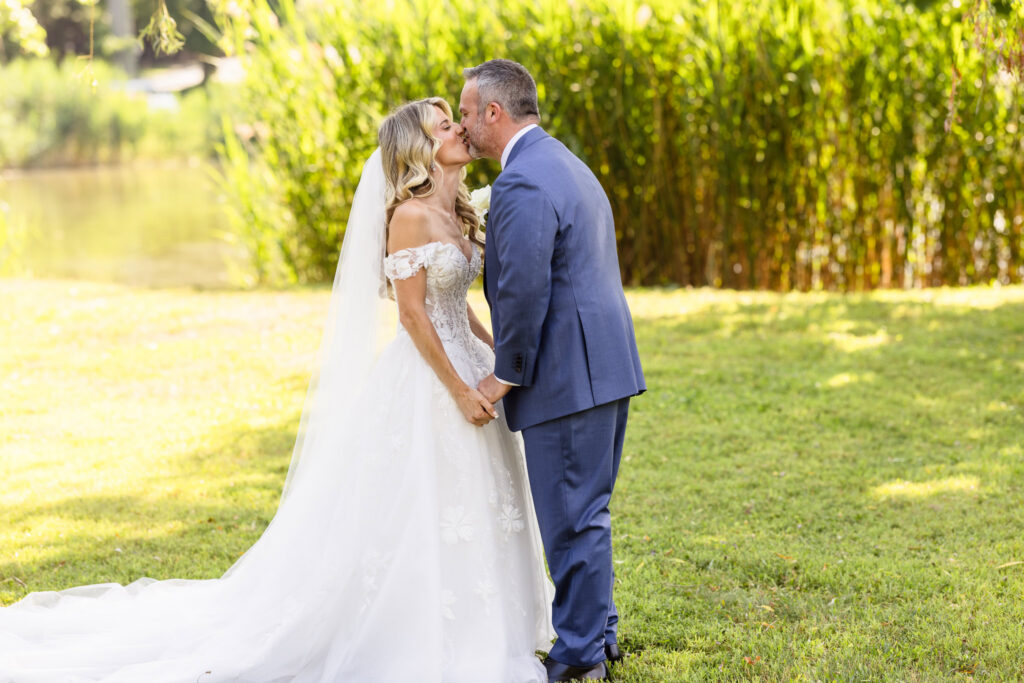 Kaity and Sean sharing a kiss outdoors after their first look at Flowerfield.