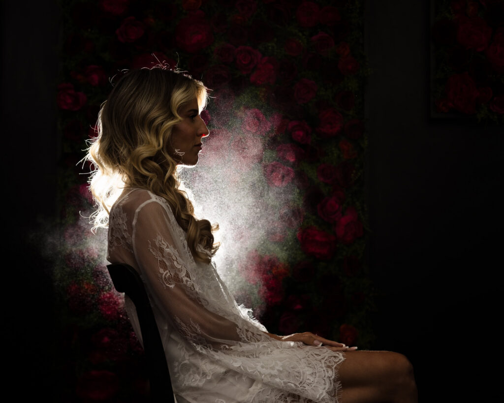 Dramatic backlit portrait of Kaity in her lace robe during morning preparations at Flowerfield.