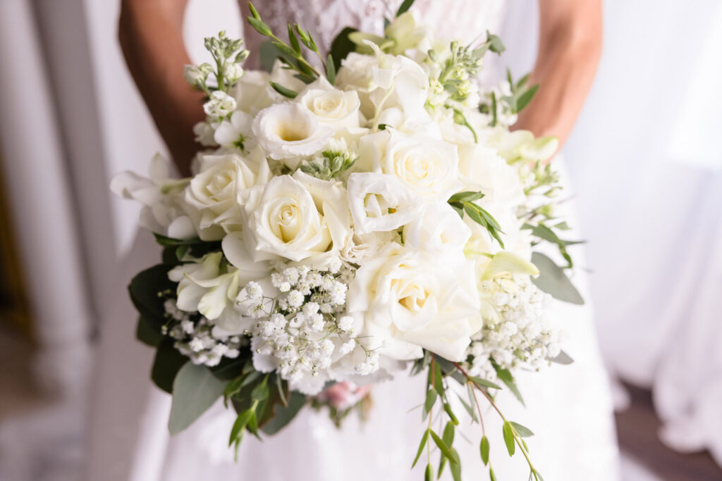 Close-up of Kaity’s white rose and greenery bridal bouquet for her summer wedding at Flowerfield.