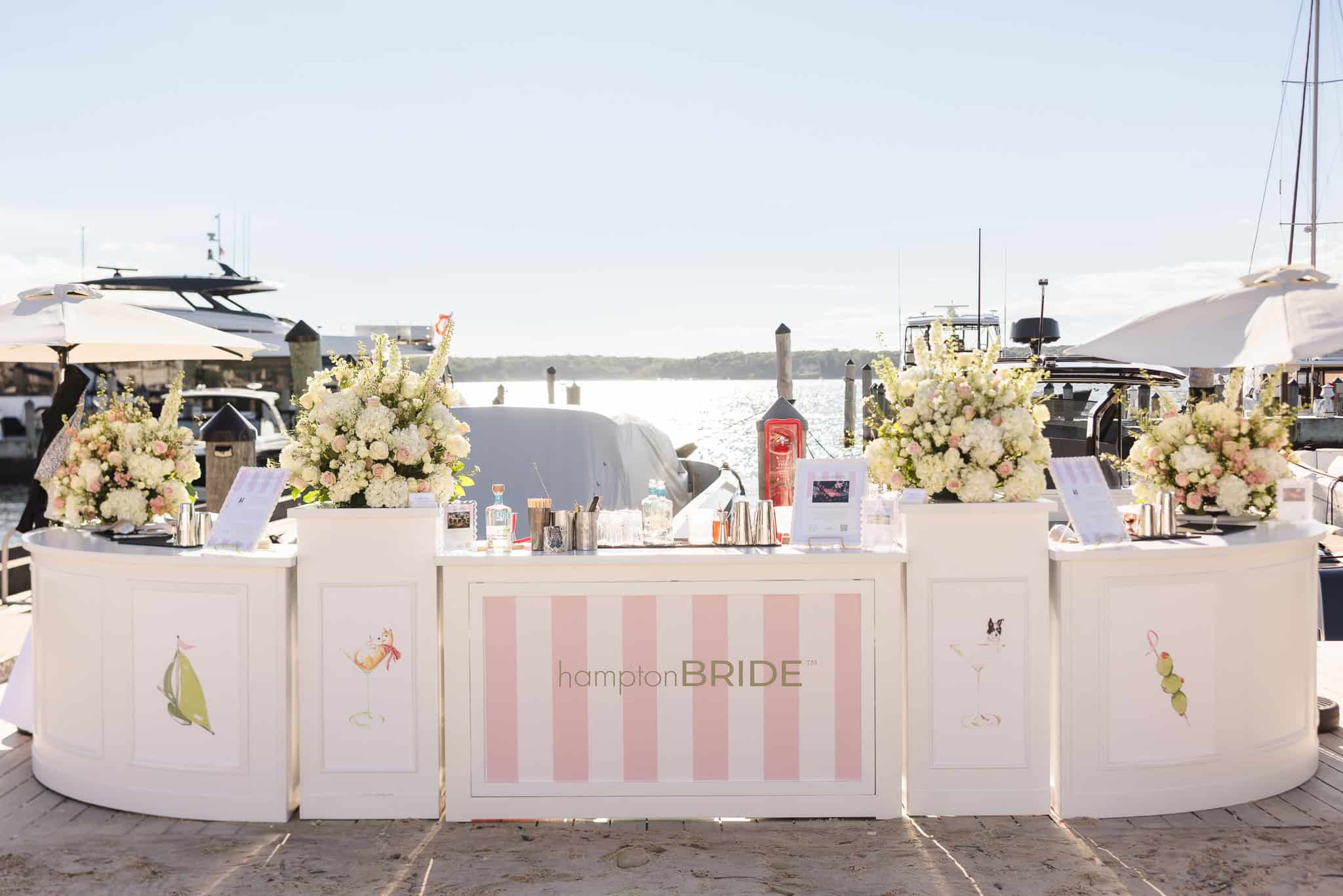 Waterfront cocktail bar with pink and white florals at hamptonBRIDE’s A Toast to Summer at EHP Resort in East Hampton.