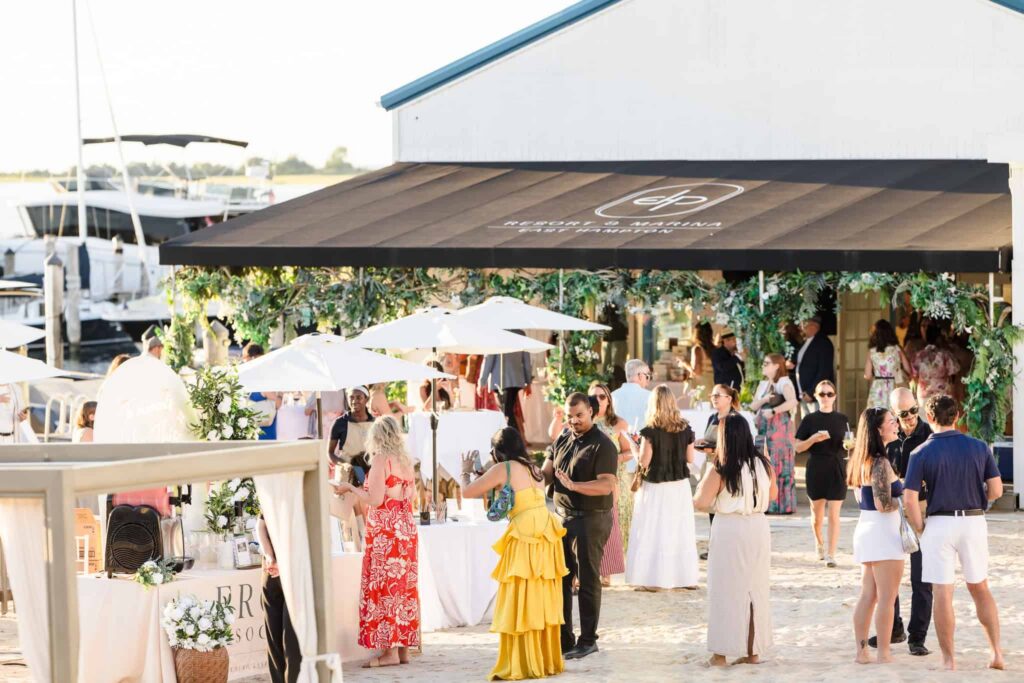 Wedding professionals gathering outside Shagwong Boat Club at EHP Resort during the summer event.