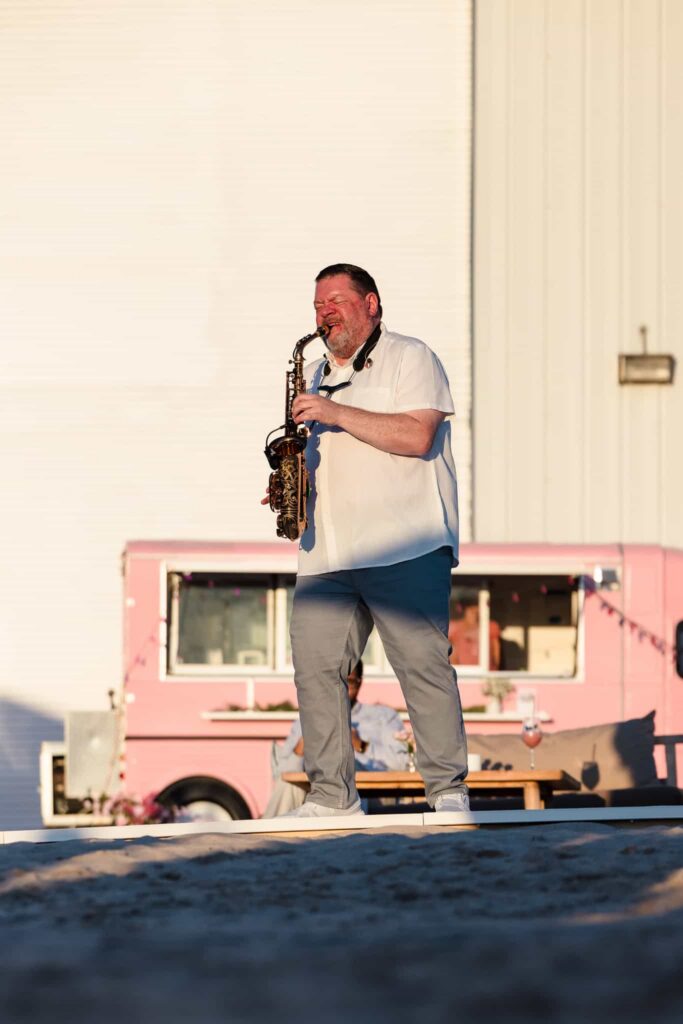 Saxophonist performing outdoors during hamptonBRIDE’s A Toast to Summer at EHP Resort.