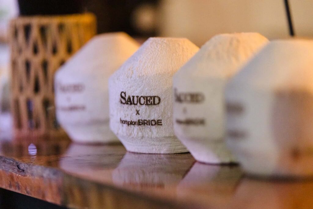 Sauced x hamptonBRIDE branded coconuts displayed during the East End wedding community event at EHP Resort.
