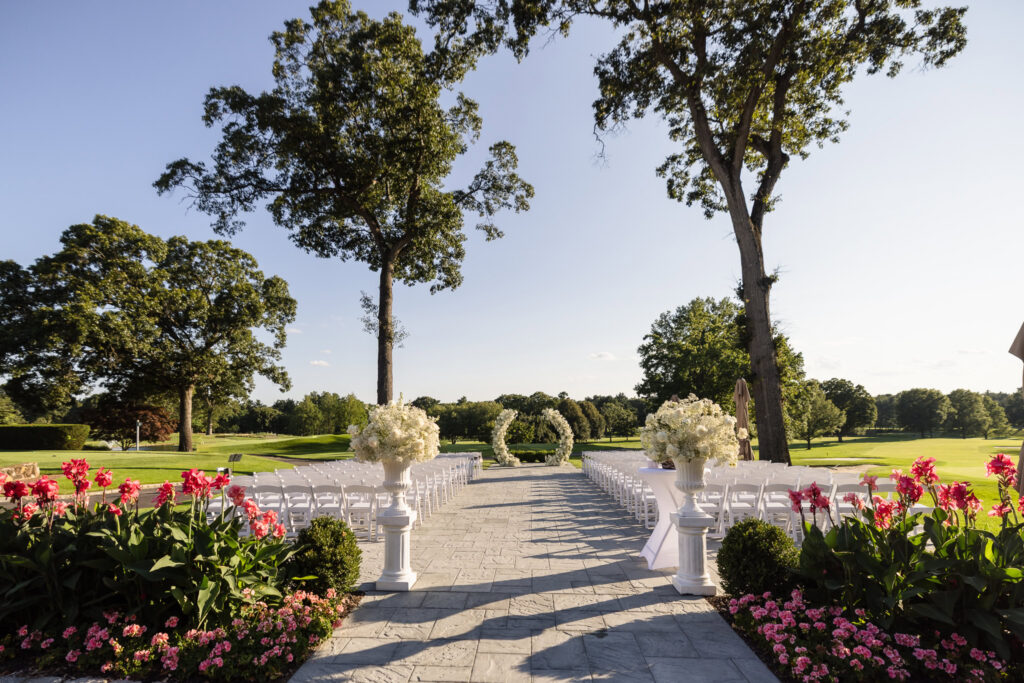 Outdoor wedding ceremony setup overlooking the golf course at The Muttontown Club in East Norwich, New York.