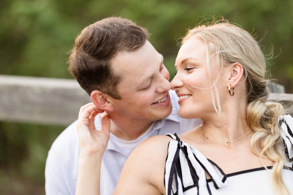 Emily and Corbin share a close, playful moment during their out-of-town engagement session on Long Island.