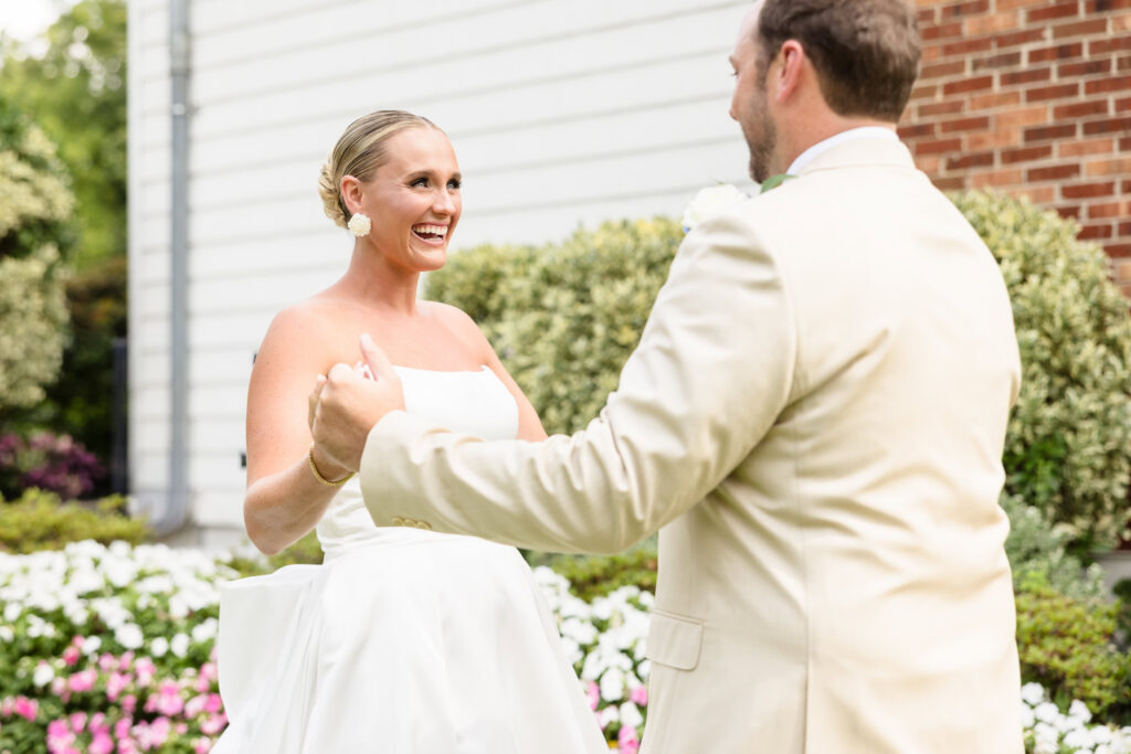 Quinn smiling at Josh during their first look before the ceremony at Sea Cliff Manor.