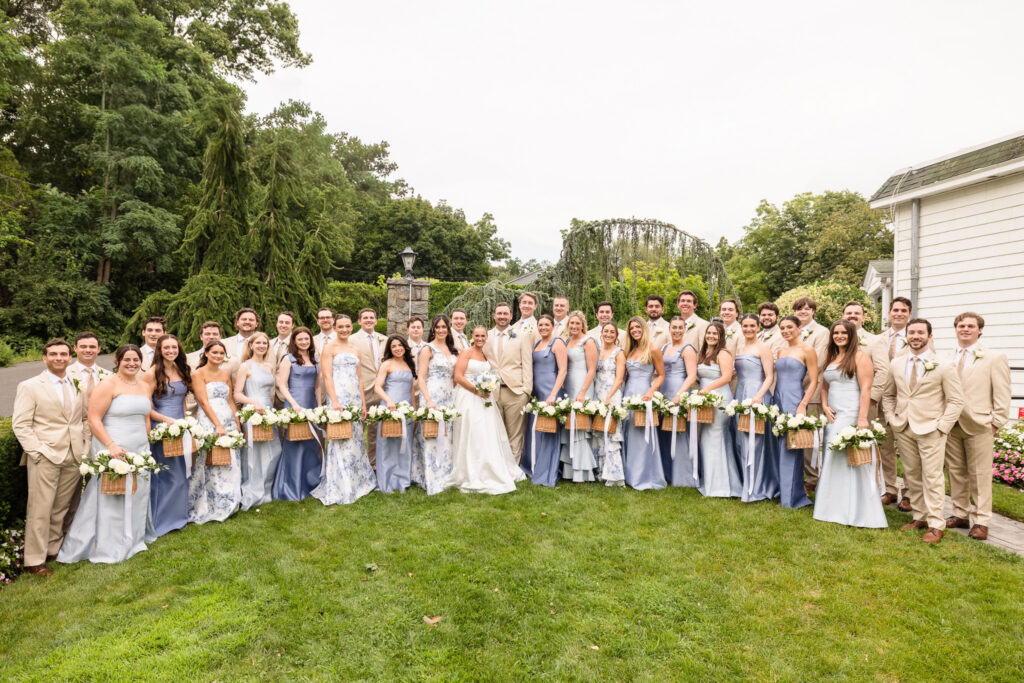 Quinn and Josh surrounded by their large wedding party in the gardens at Sea Cliff Manor.