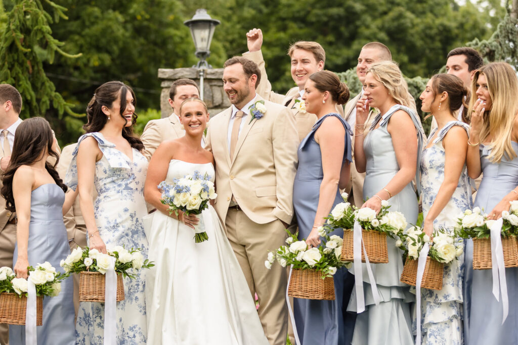 Quinn and Josh laughing with members of their large wedding party before the ceremony at Sea Cliff Manor.
