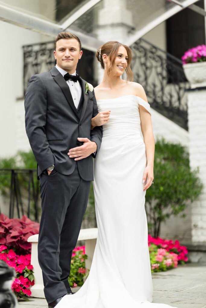 Bride and groom standing together outside during their Swan Club on the Harbor wedding.