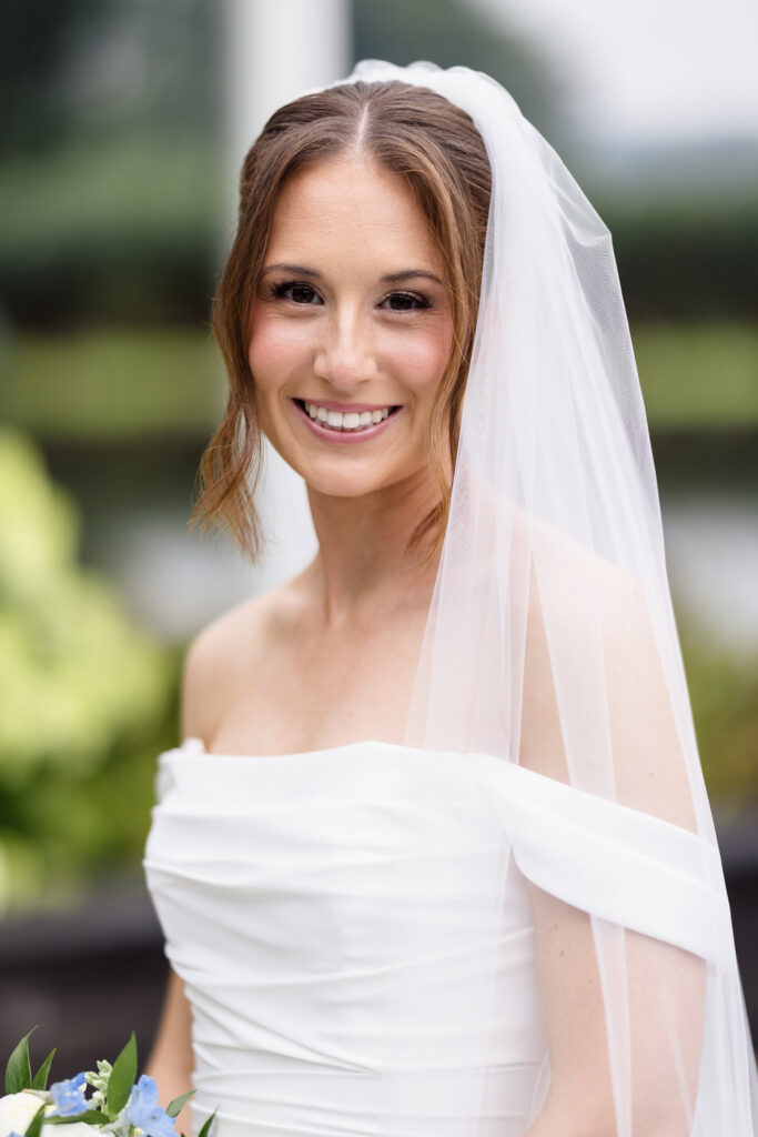 Close-up bridal portrait of Tori in her off-the-shoulder wedding gown and veil at The Swan Club.